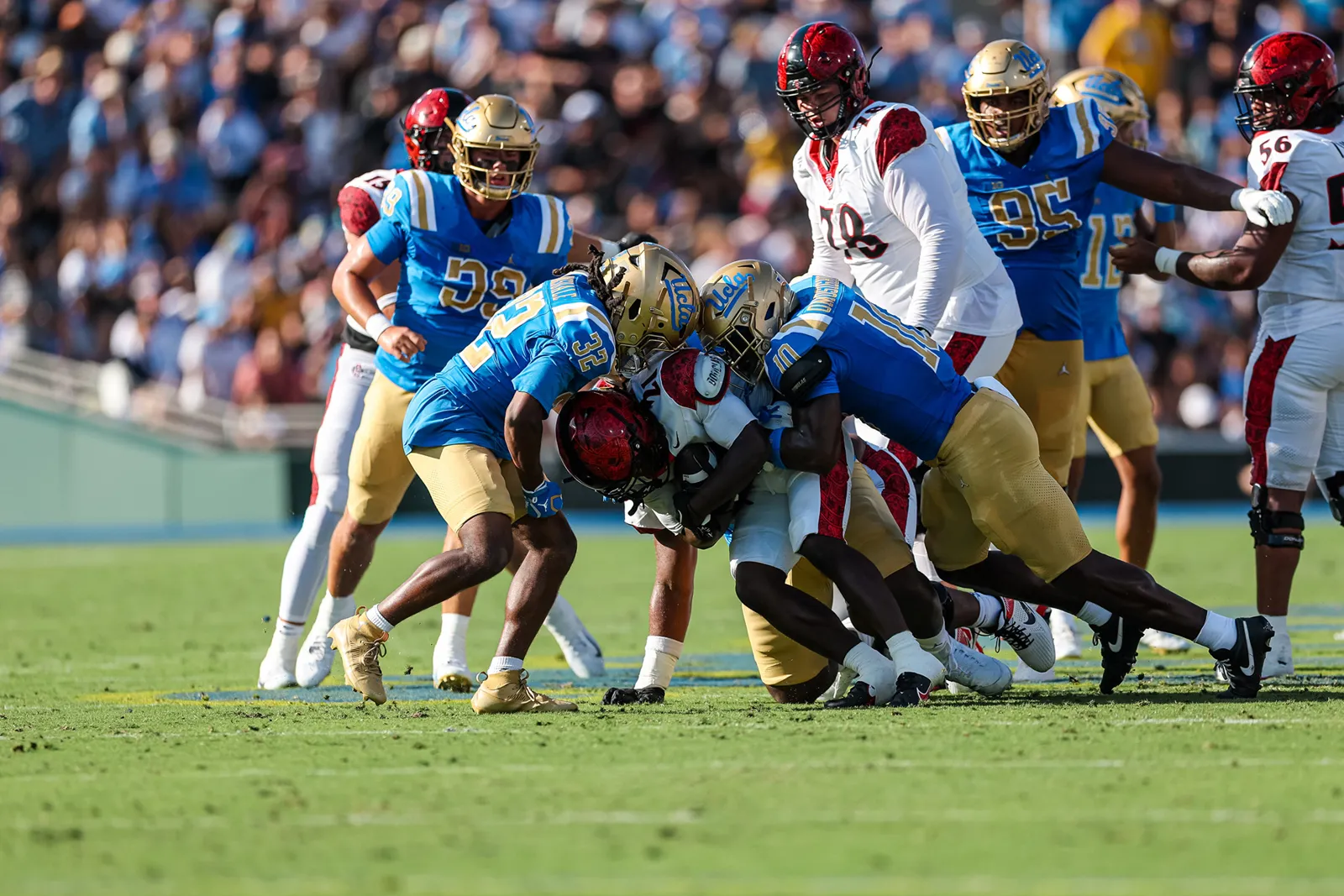 Sammy Omosigho and Derrick Barksdale make a tackle