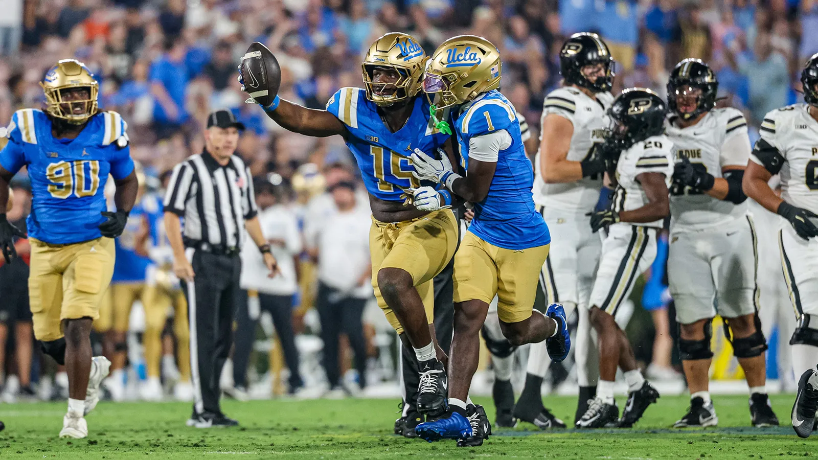 Sahir West and Scooter Jackson celebrate a fumble recovery by West