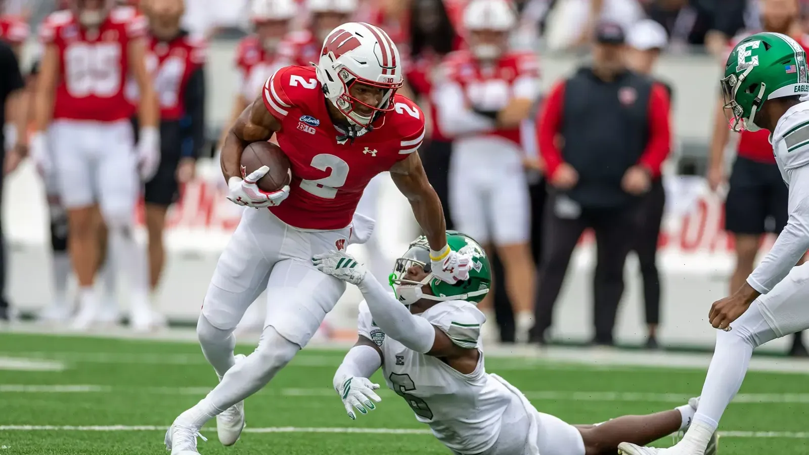 Wisconsin running back carries the football through a tackle against Eastern Michigan