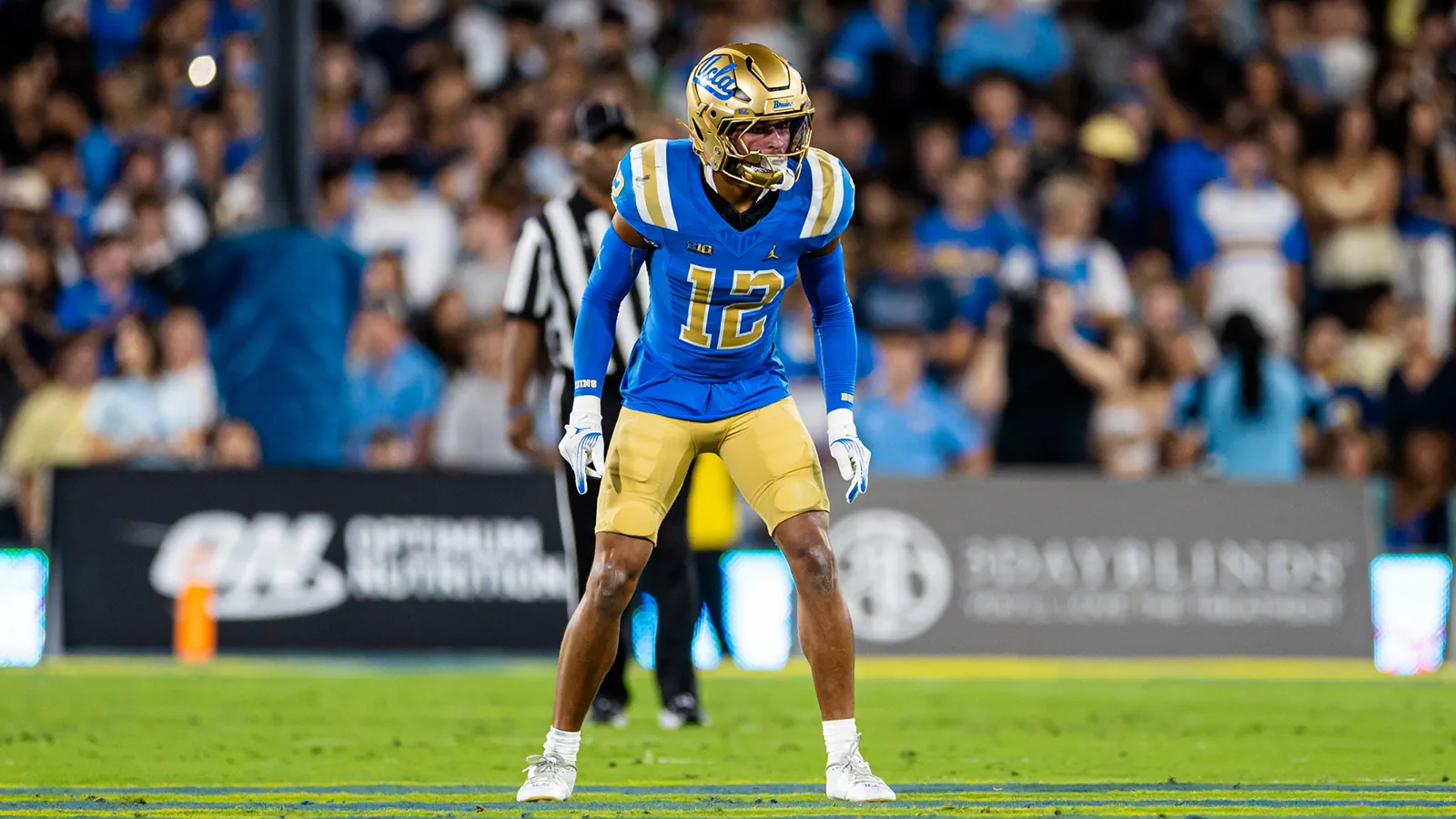 UCLA football player in blue and gold ahead of the Wisconsin matchup