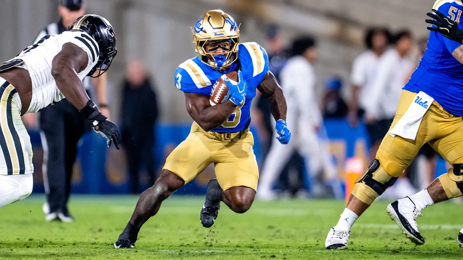 Running back Wayne Knight runs through the Purdue defense while carrying the football