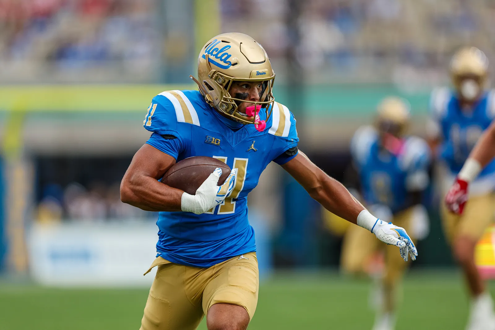Landon Ellis carries the ball